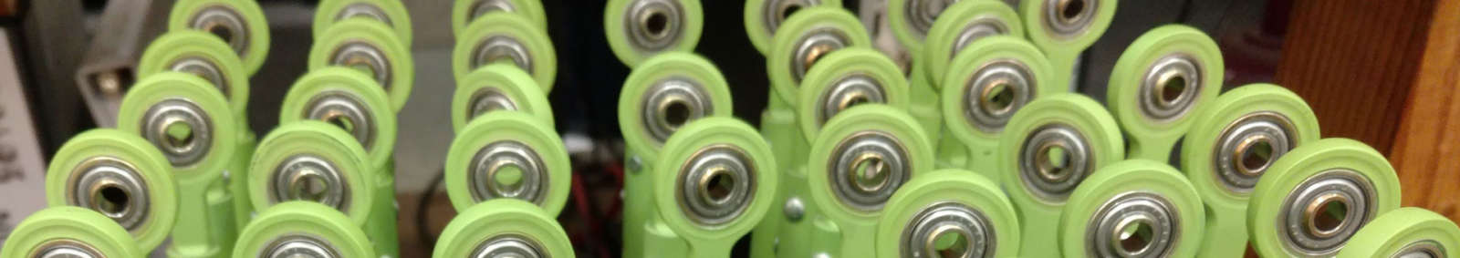 A close up of a group of green bowling balls.