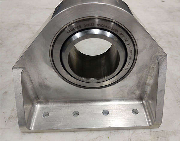 A stainless steel bearing housing for a machine.