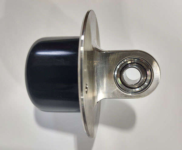 A stainless steel ball bearing on a white surface.