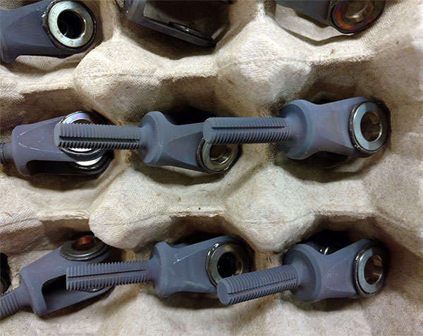 A cardboard box with a lot of screws in it.