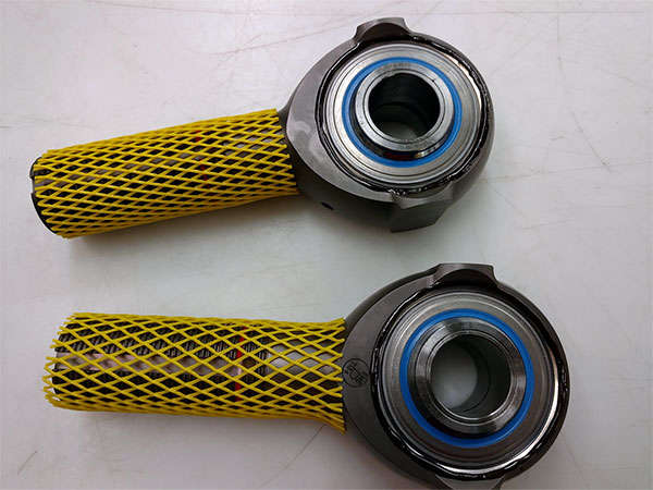 A pair of yellow mesh bearings on a white surface.