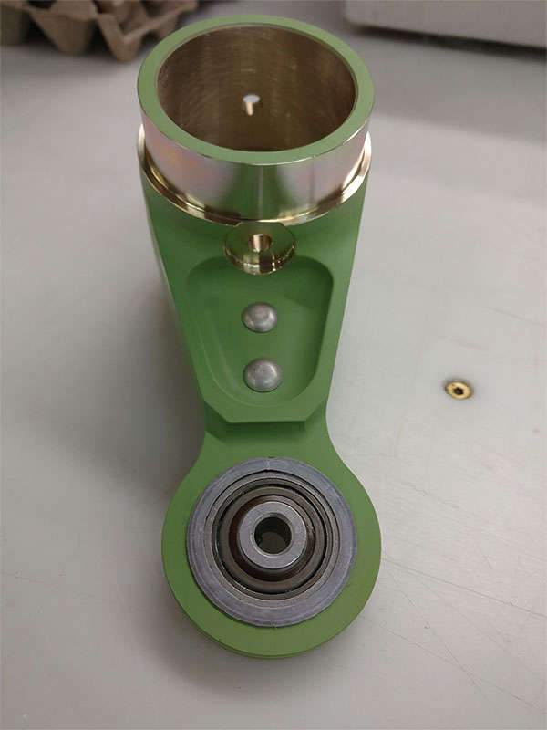 A green plastic cup with a metal ring on it.