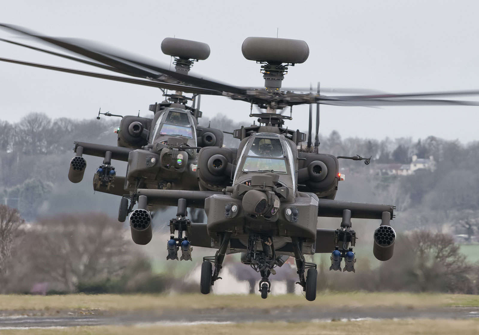 A pair of military helicopters flying in formation showcasing aerospace defense capabilities.