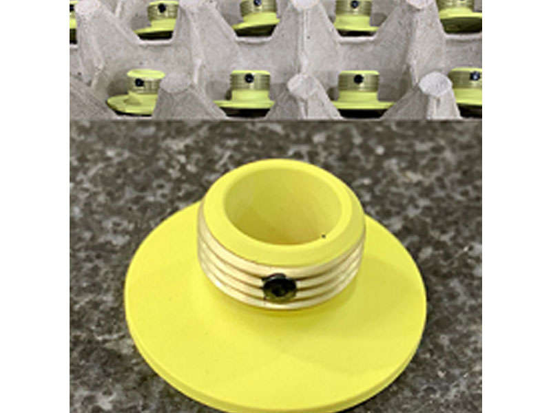 Manufacturing a yellow plastic cup with a hole.