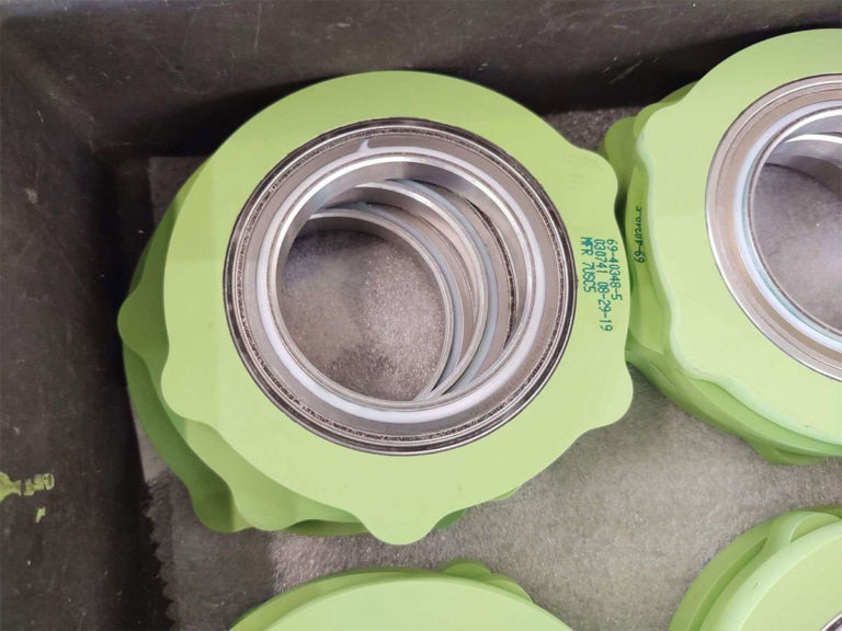 A box containing an assembly of plastic flanges in green.