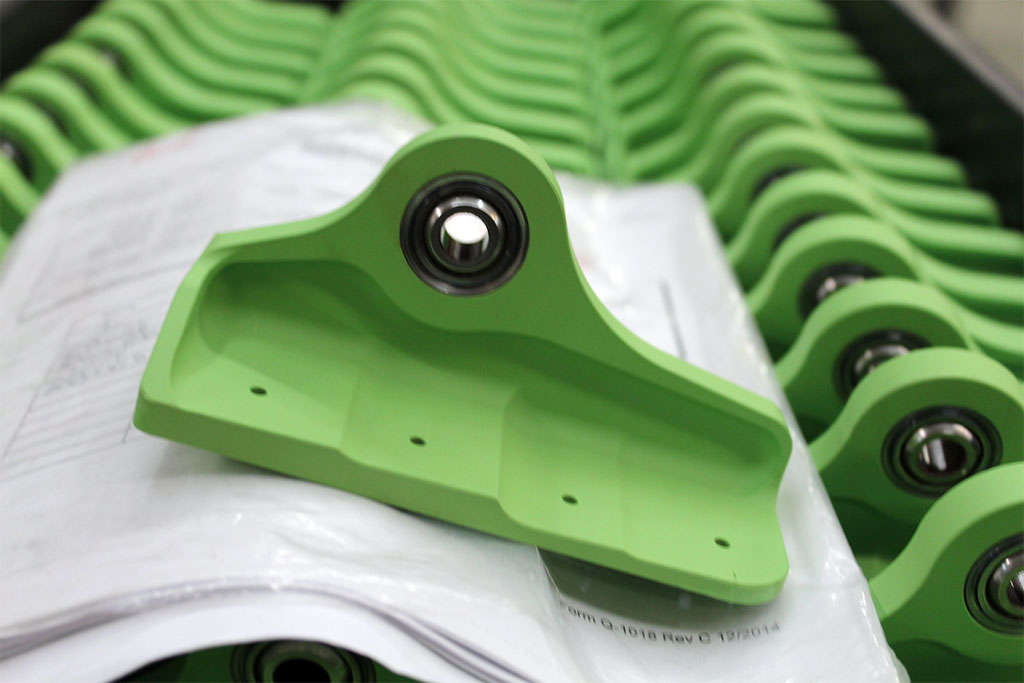 A stack of green plastic bushings stacked on top of each other.