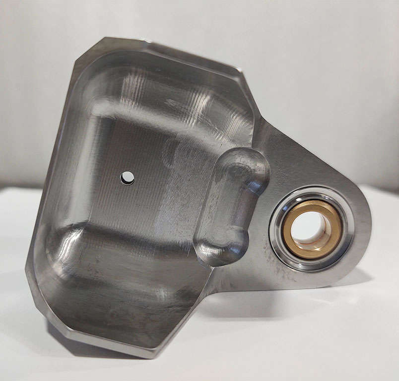 A stainless steel plate with a hole, suitable for bushing installation.